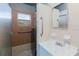 Standard bathroom featuring a glass-enclosed shower and sink with a mirror at 2825 N Taliaferro N Ave, Tampa, FL 33602