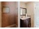 The bathroom features a tiled shower with a grab bar and a vanity with a dark wood cabinet at 2825 N Taliaferro N Ave, Tampa, FL 33602