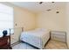 Simple bedroom featuring tile floors, natural light, and a comfortable double bed with pastel-patterned comforter at 2825 N Taliaferro N Ave, Tampa, FL 33602
