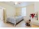 Bright bedroom features tile floors, a window, and a door at 2825 N Taliaferro N Ave, Tampa, FL 33602