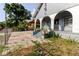 Charming home exterior featuring a welcoming front porch with arches and potted plants at 2825 N Taliaferro N Ave, Tampa, FL 33602