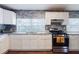Modern kitchen with granite countertops, white cabinets, and stainless steel appliances at 2825 N Taliaferro N Ave, Tampa, FL 33602