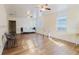 Spacious living room with wood-look flooring, ceiling fans, and natural light at 2825 N Taliaferro N Ave, Tampa, FL 33602
