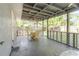 Large, shaded outdoor patio features a dining area and views of the backyard at 2825 N Taliaferro N Ave, Tampa, FL 33602