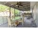 Covered porch features a glass top table with 4 chairs and two ceiling fans at 2825 N Taliaferro N Ave, Tampa, FL 33602