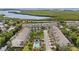 An aerial shot of condo buildings and townhomes, lush greenery, and a waterfront view at 3147 Oyster Bayou Way, Clearwater, FL 33759