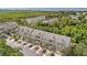 An aerial view of tan townhomes with palm-lined streets in a scenic community at 3147 Oyster Bayou Way, Clearwater, FL 33759