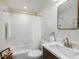Well-lit bathroom features a shower/tub combo and a dark-stained vanity at 3147 Oyster Bayou Way, Clearwater, FL 33759