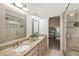 Bathroom features double sinks, granite countertops, and a tiled walk-in shower at 3147 Oyster Bayou Way, Clearwater, FL 33759