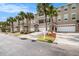 Charming townhomes featuring well-manicured lawns, palm trees, and convenient two-car garages with driveways at 3147 Oyster Bayou Way, Clearwater, FL 33759