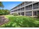 Low-angle shot of a multi-level condo with screened balconies and well-manicured lawn at 3147 Oyster Bayou Way, Clearwater, FL 33759