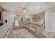Comfortable living room featuring a sectional sofa, a ceiling fan, and hardwood floors at 3147 Oyster Bayou Way, Clearwater, FL 33759