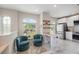 Inviting living space with bright windows, casual seating, hardwood floors, and direct access to the kitchen at 3147 Oyster Bayou Way, Clearwater, FL 33759