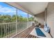 Inviting screened porch with views of lush greenery, a blue pillow, and a yoga mat at 3147 Oyster Bayou Way, Clearwater, FL 33759