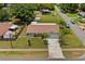 An aerial view of a home with a long driveway, a spacious backyard, and mature trees surrounding the property at 39243 6Th Ave, Zephyrhills, FL 33542