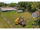 Spacious backyard featuring a playset, shed, and ample green space for outdoor activities at 39243 6Th Ave, Zephyrhills, FL 33542
