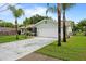Well-maintained home with a two-car garage, lush lawn, and mature landscaping including palm trees at 39243 6Th Ave, Zephyrhills, FL 33542