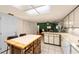 Open kitchen featuring an island, eat-in breakfast area, and white appliances at 39243 6Th Ave, Zephyrhills, FL 33542