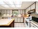 Spacious kitchen featuring ample cabinet storage, tile floors, and white appliances at 39243 6Th Ave, Zephyrhills, FL 33542