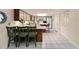Bright kitchen featuring white cabinets, bar stool seating, and modern appliances at 39243 6Th Ave, Zephyrhills, FL 33542
