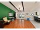 Open living space with wood floors, high ceilings, french doors to backyard and a water cooler at 39243 6Th Ave, Zephyrhills, FL 33542