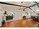 Open floor plan with hardwood flooring, kitchen island, bar seating, and comfortable living room at 39243 6Th Ave, Zephyrhills, FL 33542