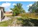 Large fenced backyard with mature trees provides ample outdoor living space at 4012 W Pearl Ave, Tampa, FL 33611