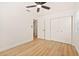 Cozy bedroom boasts wood-look floors, a ceiling fan, closet space, and neutral walls at 4012 W Pearl Ave, Tampa, FL 33611