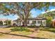 Charming home with mature tree and manicured lawn enhances curb appeal at 4012 W Pearl Ave, Tampa, FL 33611