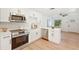 Modern kitchen with stainless steel appliances, white cabinets, and stylish fixtures at 4012 W Pearl Ave, Tampa, FL 33611