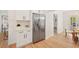 Well-lit kitchen featuring stainless steel refrigerator and modern white cabinetry at 4012 W Pearl Ave, Tampa, FL 33611