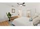 Bright main bedroom featuring a ceiling fan, natural lighting, and ensuite at 4012 W Pearl Ave, Tampa, FL 33611