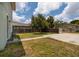 Spacious, fenced backyard with a lush lawn, mature tree, and a paved area, great for outdoor activities at 4301 5Th N Ave, St Petersburg, FL 33713
