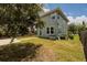 View of a fenced-in backyard featuring a spacious grassy area, a shed, and a patio with outdoor furniture at 4301 5Th N Ave, St Petersburg, FL 33713