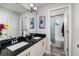 Charming bathroom featuring double sinks, black granite countertop and a separate toilet and shower room at 4301 5Th N Ave, St Petersburg, FL 33713