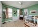 Bright green Bedroom with dresser, rocker, and view of the ensuite bathroom at 4301 5Th N Ave, St Petersburg, FL 33713