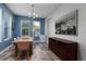 Bright dining room with modern chandelier, painting, and wood-look tile flooring at 4301 5Th N Ave, St Petersburg, FL 33713