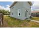 Two-story home featuring a spacious backyard, a grassy area, and a walkway leading to the entrance at 4301 5Th N Ave, St Petersburg, FL 33713