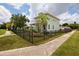 Charming two-story home with a black metal fence, a well-manicured lawn, and lush landscaping at 4301 5Th N Ave, St Petersburg, FL 33713
