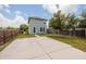 Backyard view of a two-story home, showing a spacious concrete driveway and a well-maintained lawn at 4301 5Th N Ave, St Petersburg, FL 33713