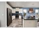 Modern kitchen with stainless steel appliances, sleek countertops, and an open view to the living area at 4301 5Th N Ave, St Petersburg, FL 33713