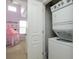Stackable white washer and dryer conveniently located near the bedroom with a peek of the tent at 4301 5Th N Ave, St Petersburg, FL 33713