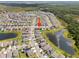 Expansive aerial view featuring homes, ponds, and lush landscaping, showing the community's layout at 4403 Eternal Prince, Sun City Center, FL 33573
