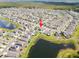 Aerial view showcasing homes near a scenic pond with abundant green space at 4403 Eternal Prince, Sun City Center, FL 33573