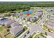 Aerial neighborhood view showing homes, a pond, and surrounding greenery, convenient location at 4403 Eternal Prince, Sun City Center, FL 33573