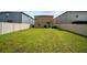 The large backyard with a lawn and a privacy fence offers outdoor enjoyment at 4403 Eternal Prince, Sun City Center, FL 33573