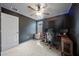 A finished bedroom featuring a ceiling fan, a window with natural light, and sound dampening panels at 4403 Eternal Prince, Sun City Center, FL 33573