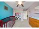 This Bedroom features a crib, dresser, shelves, closet with clothes, and colorful decor at 4403 Eternal Prince, Sun City Center, FL 33573