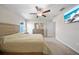 Bright bedroom featuring a ceiling fan, dresser, and queen size bed at 4403 Eternal Prince, Sun City Center, FL 33573