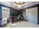 A finished bedroom featuring a ceiling fan, sound dampening panels, and blue curtains at 4403 Eternal Prince, Sun City Center, FL 33573